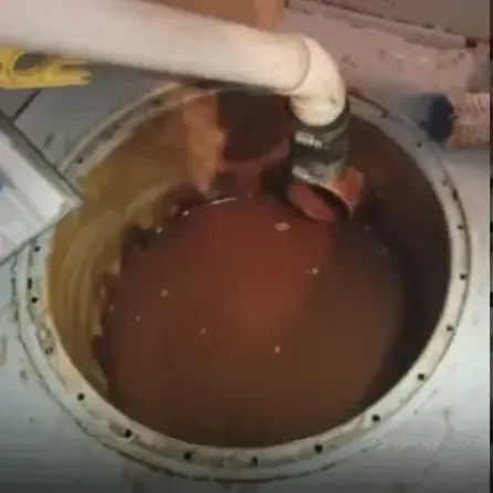 Basement sump pit filled to the rim with water