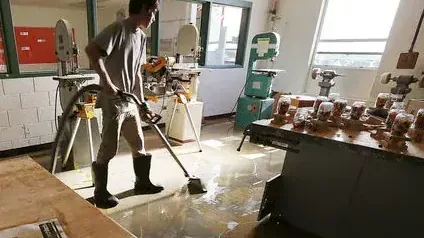 Water extraction underway on a soaked floor inside a home